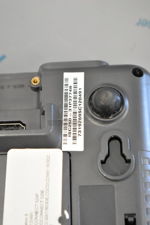 Alt text: Close-up of Ingenico iSC Touch 250 credit card reader with visible barcode and serial number label.