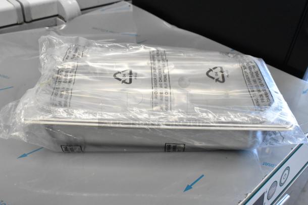 Stainless steel drop-in bin, new in plastic packaging, included in a set of four.
