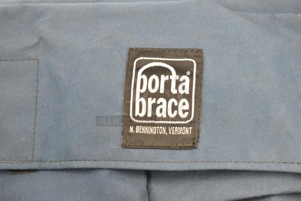 Blue Porta Brace bag with black logo patch reading "Porta Brace, N. Bennington, Vermont." Durable fabric, good condition.