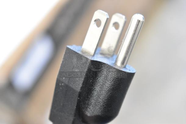 Close-up image of a plug for the KoolMore KM-CGD-8HP ice cream display case, showing details of the prongs.
