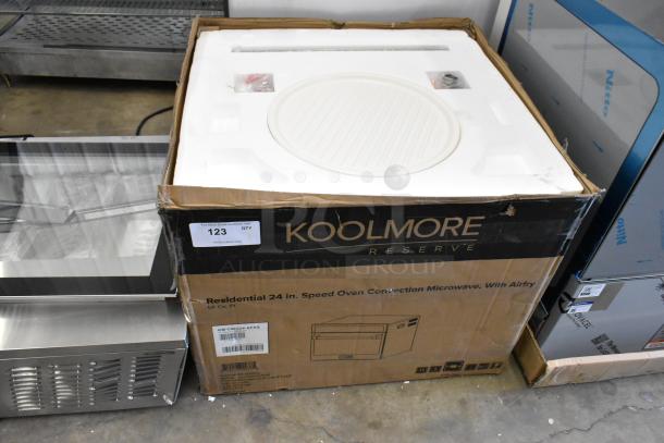 Brand new KoolMore KM-CWO24-AFSS 24 in. Speed Oven Convection Microwave in a box showing minor dents. Model and specs on packaging.
