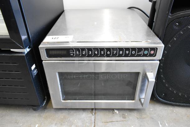 Amana HDC12A2 stainless steel commercial microwave, 120 volts, countertop model. Visible buttons, minor surface wear.