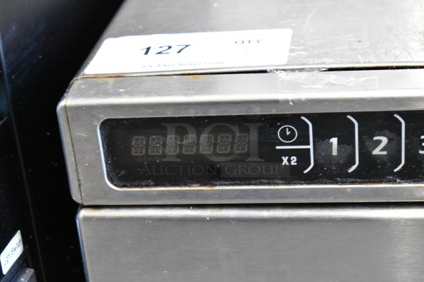 Amana HDC12A2 stainless steel commercial microwave, 120 volts, keypad controls. Auction label visible on top.