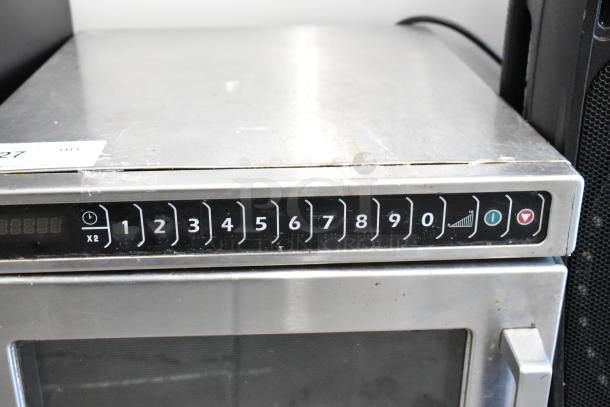 Amana HDC12A2 stainless steel commercial countertop microwave oven, 120 volts, keypad controls, visible wear on top.