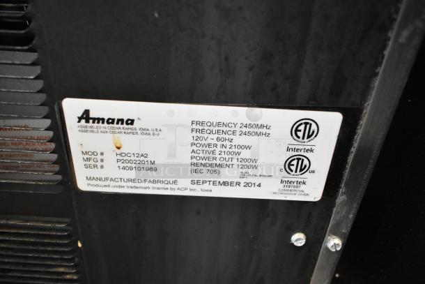 Amana HDC12A2 stainless steel commercial countertop microwave oven, 120 volts, label shows specifications and certifications.