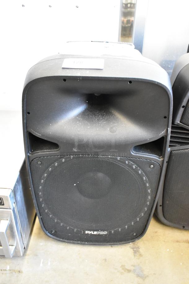 Two Pyle speakers, models PPHP1569UT and PPHP1599WU, black, visible wear, ideal for audio amplification.