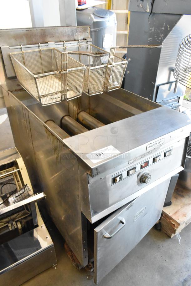Keating stainless steel commercial gas fryer with two metal baskets on casters, "Caution Hot" label visible, good condition.