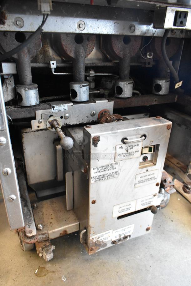 Keating stainless steel gas fryer with two fry baskets and commercial casters. Visible signs of wear on components.