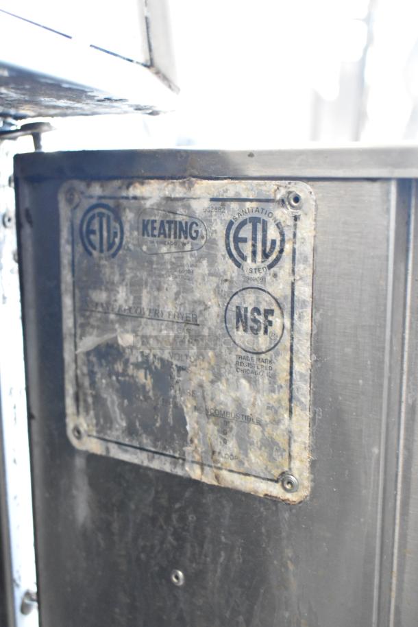 Keating stainless steel commercial deep fat fryer with two metal baskets, ETL and NSF certified, shown on casters.