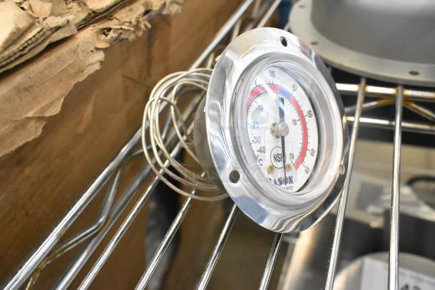 Alt text: New thermostat with chrome casing, NSF certified, includes coiled probe on metal shelf. Scratch and dent condition.