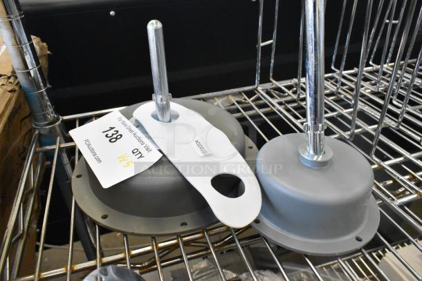 Five brand new scratch and dent items including light fixtures on wire shelving. Tag shows lot number 138, quantity x5.