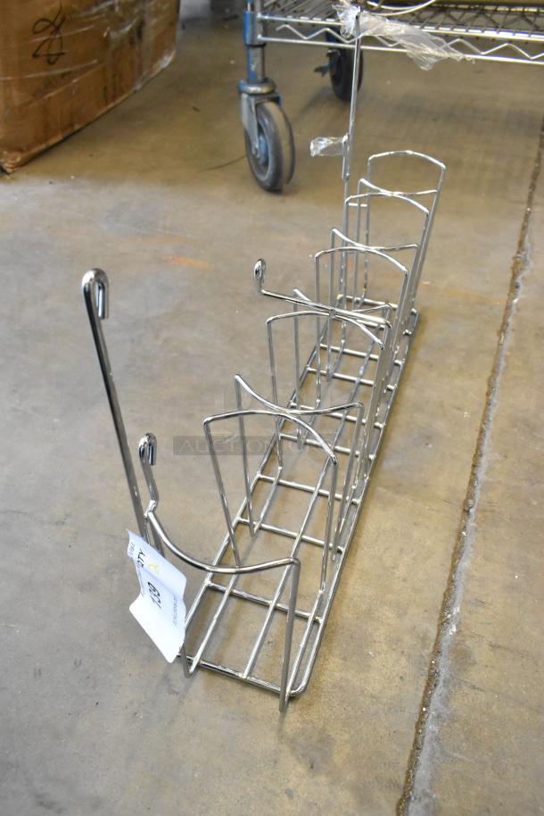 Brand new metal rack with slight scratches, featuring multiple compartments. Comes with auction label indicating 2x bid value.