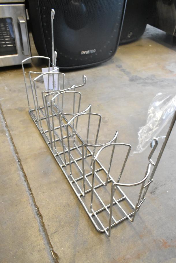 Brand new metal rack with minor scratches and dents. Sturdy frame, open design. Includes item tag. Auction features two racks.