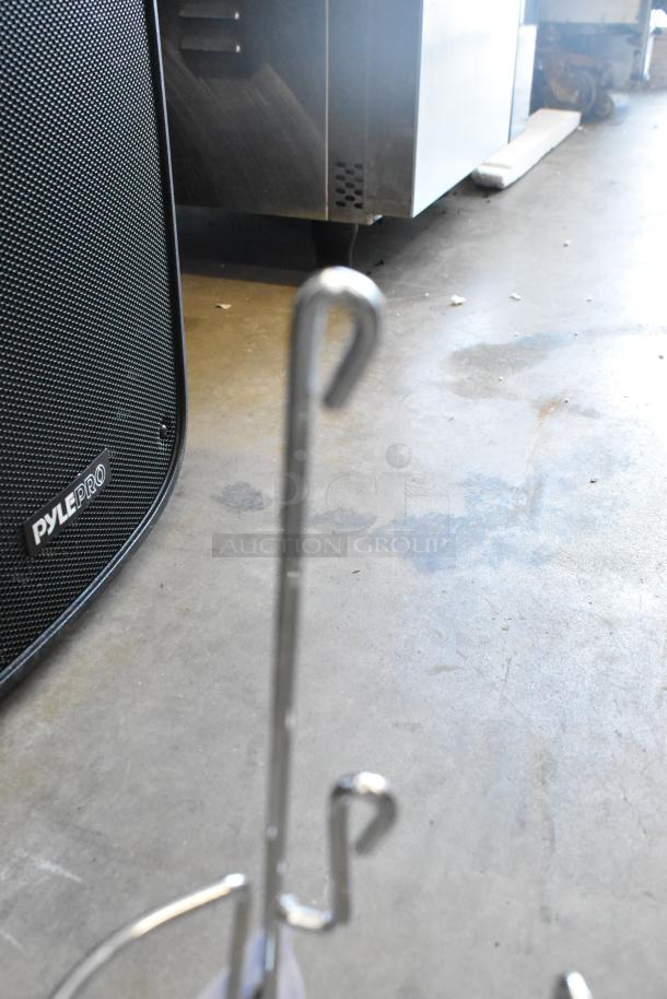 New scratch and dent metal rack, two pieces. Visible hooks, industrial setting. Ideal for double bid value auction.