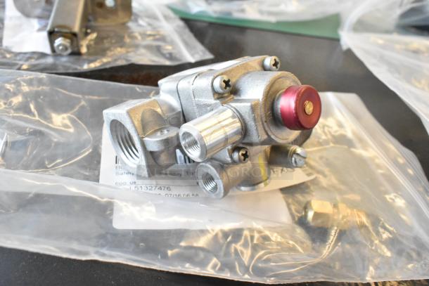 5 brand new scratch and dent items, including W2518 Conversion Kit, Robertshaw TS11K-4411-1-0, Blodgett 19323 Safety Valve, M450 Fan. Components sealed in clear packaging.