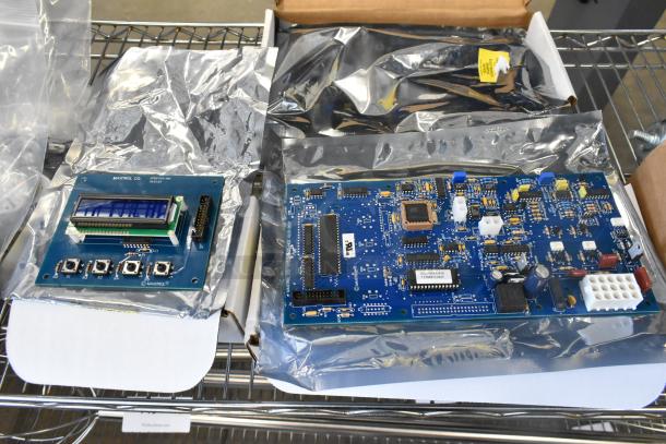 Three brand new scratch and dent items, including Lincoln CK11010005990 Digital Control Board Kit and M9026993-018-A Circuit Board, in protective packaging.
