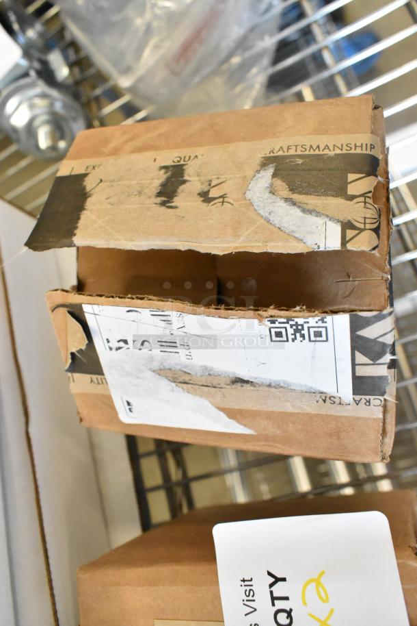 Cardboard box labeled "Kraftsm" showing signs of wear and shipping labels. Contains new scratch and dent items including Kason hinge pieces.