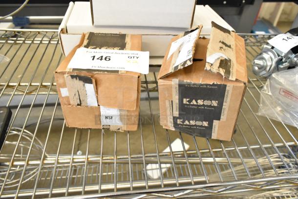 Two brand new Kason hinge boxes, scratch-and-dent condition, on a metal shelf. NSF label visible.