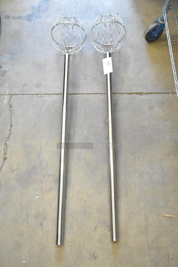 Brand new metal mixing whisks with long handles, lightly scratched. Includes auction tag. Two items available.