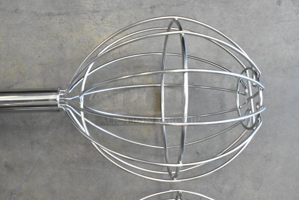 Brand new metal mixing whisk with long handle, slight scratch and dent. Features durable wire loops for efficient mixing.