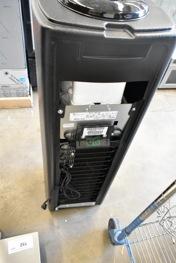 BRAND NEW Oasis QBPD1SK floor style water cooler base, 115V, 1 phase, scratch and dent condition. Tags show model and voltage details.