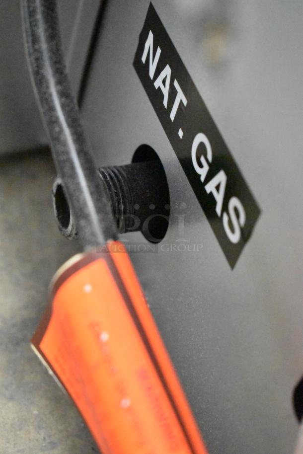 Close-up of natural gas inlet labeled "NAT. GAS" on a Moffat Turbofan G32D5-1 convection oven, stainless steel.