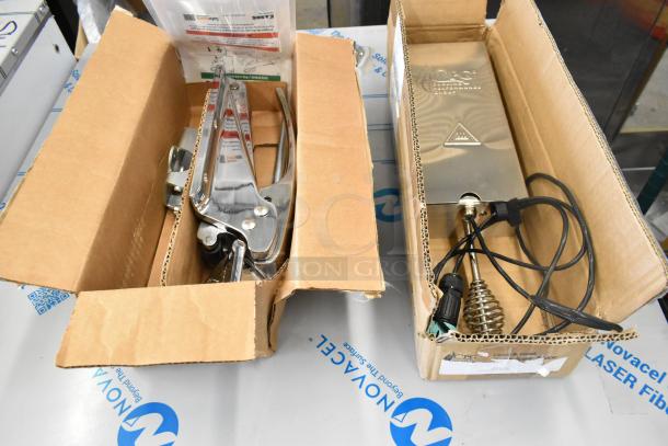 Two brand new items in boxes: Kason® 10055000020 door latch and Cooking Performance Group 351SMKR208 smoker box.