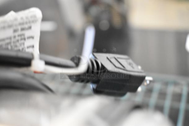 Close-up of the power cord for the Backyard Pro 554BSG12 Butcher Series Electric Meat Grinder, showing plug and label details.