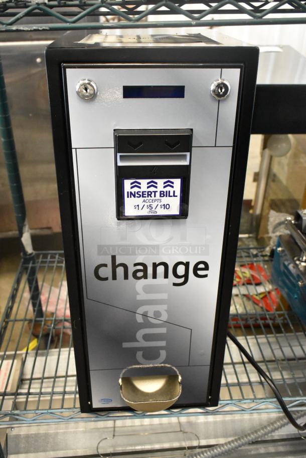 "Brand new 28ACM1250 Seaga CM1250 change machine, minor scratches, accepts $1/$5/$10 bills, secure metal casing."