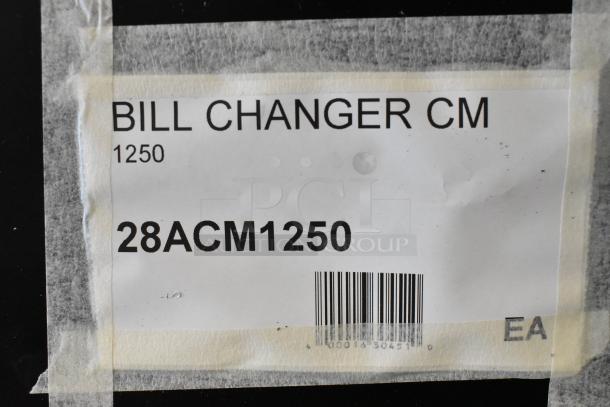 Alt text: "Seaga CM1250 Change Machine model 28ACM1250 label, brand new with minor scratches and dents, barcode visible."