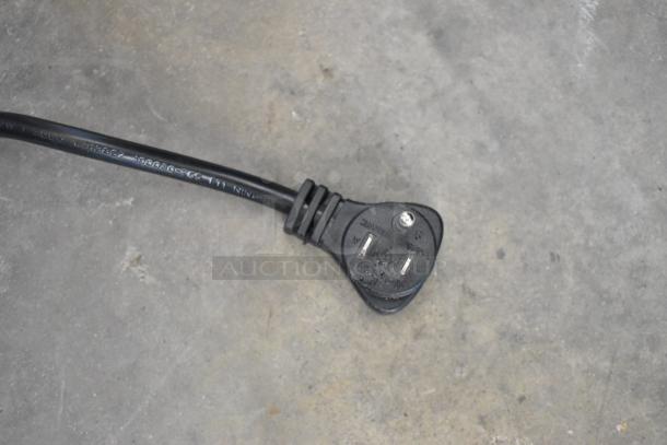 Close-up of the power cord plug for a Seaga CM1250 Change Machine, model 28ACM1250, showing slight wear.