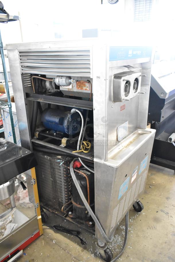 Taylor 754-27 stainless steel soft serve ice cream machine with 2 flavors and twist option. Commercial casters, 208/230V, 1-phase.