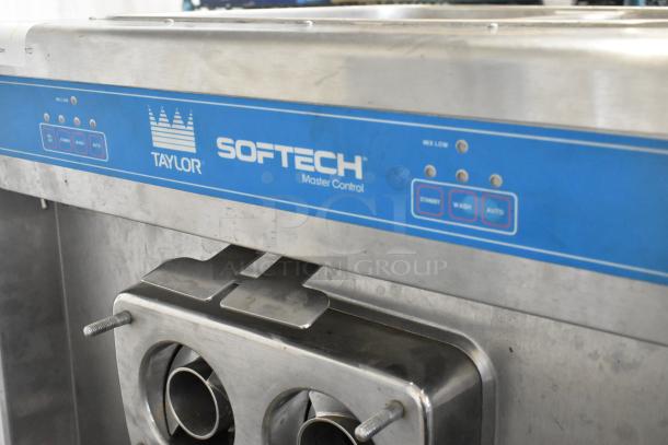 Taylor 754-27 stainless steel 2-flavor soft serve machine with twist option on casters, 208/230V, 1 phase. Visible master control panel.