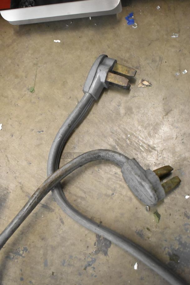 Power cords for Taylor 754-27 Soft Serve Ice Cream Machine, showing commercial-grade plugs on the concrete floor.
