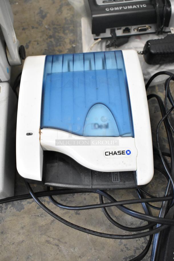 Lot of various items including a Chase-branded credit card reader with cables, showing signs of wear.
