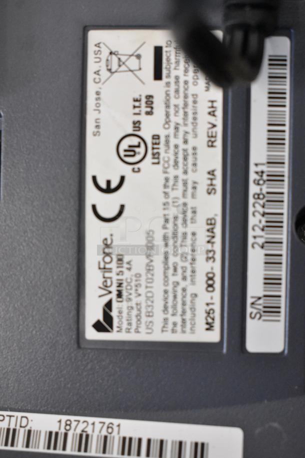 Label on VeriFone Omni 5100 credit card reader with model, compliance, and serial number details. Auction item condition unspecified.