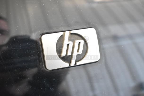 HP DesignJet Z6100 large format printer, floor style, 115 volts, 1 phase, with visible HP logo on dark surface.
