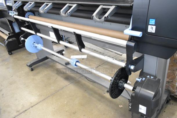 HP DesignJet Z6100 large format printer, floor model, 115 volts, 1 phase. Features roll holders, good condition.