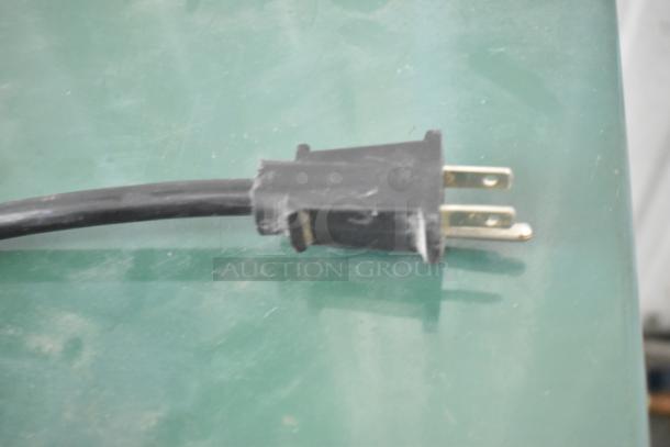 Close-up of a black electrical plug attached to the Macair HX25A-1 Metal Refrigerated Air Dryer, 115 Volts, 1 Phase.