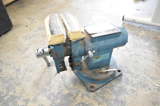 Larin APV-5S all-purpose bench vise, blue, with wear and rust. Tightens but won't loosen. Label visible on base.