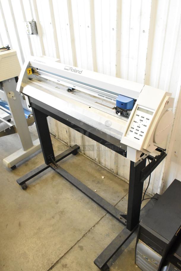 Roland Camm-1 Pro GX-300 Sign Maker, 100-240V, 1 Phase, in good condition, vertical stand, visible control panel.