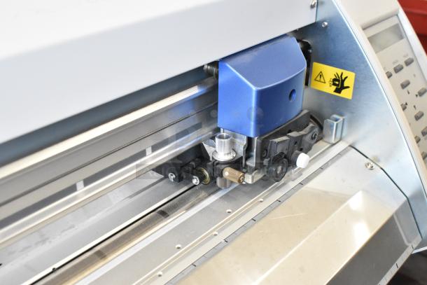 Roland Camm-1 Pro GX-300 Sign Maker, blue and silver, 100-240 volts, 1 phase, in good condition with safety label visible.
