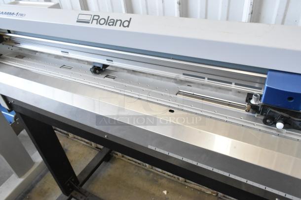 Roland Camm-1 Pro GX-300 sign maker, 100-240V, 1 phase. Features durable metal frame, clean condition, manufacturer logo visible.