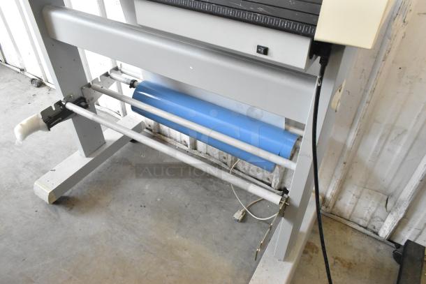 Mimaki CG-60EX Cutting Plotter, used condition, 120 Volts, 1 Phase. Featuring a robust frame and blue material roller.