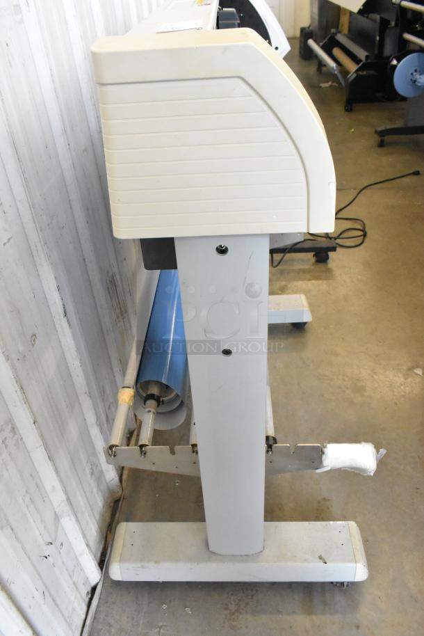 Mimaki CG-60EX Cutting Plotter, 120V, 1 Phase, shown from side. Includes roll feeder, light wear visible on base.