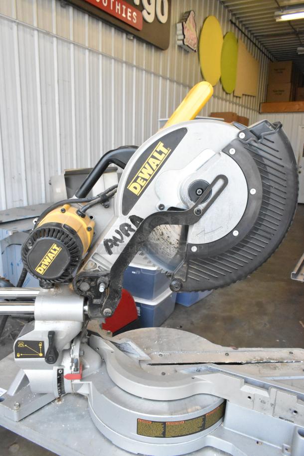 DeWalt DW718 15 Amp Corded Compound Single Bevel Miter Saw, 120 Volts, used condition. Visible DeWalt branding and safety labels.