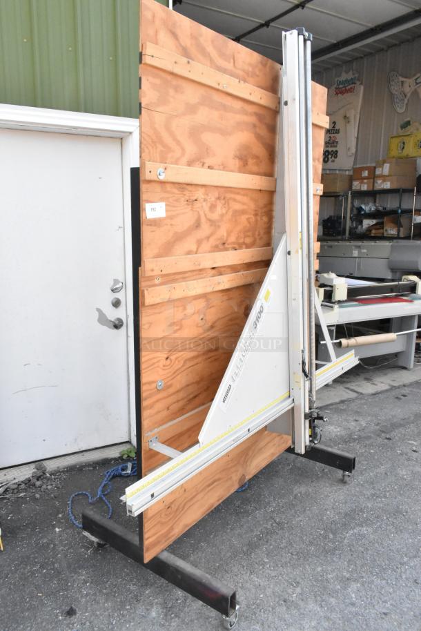 Fletcher 3100 63" multi-material cutter on commercial casters, features durable frame and measurement markings, excellent condition.
