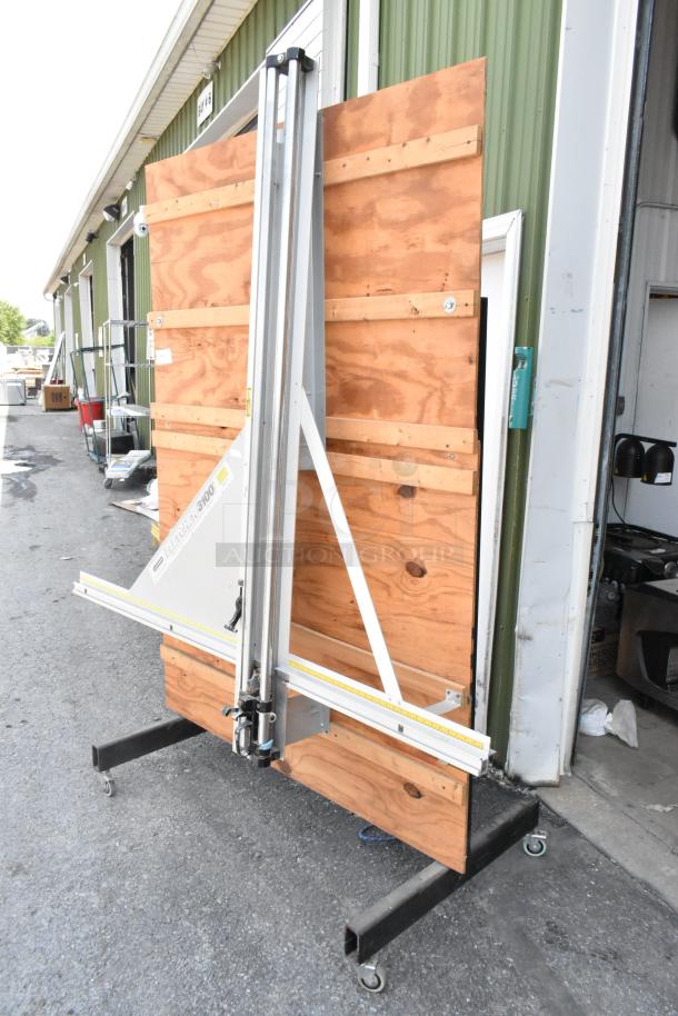 Fletcher 3100 63" multi-material cutter on commercial casters, excellent condition, metal frame, wood backboard.