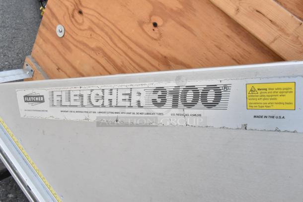 Fletcher 3100 63" Multi-Material Cutter, commercial casters, visible wear, safety and usage labels, Made in the USA.