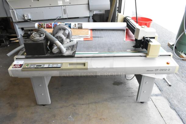 Mimaki CF-0912-2 Flatbed Cutter with control panel. Visible wear; includes vacuum pump and piping.